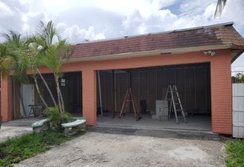 Exterior of Chula Vista, California home with old double garage door removed, ready for new installation.